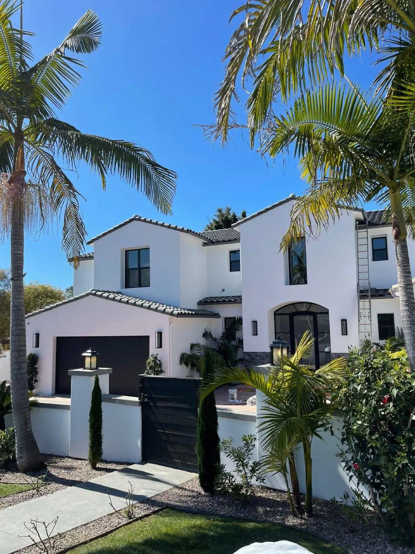 wide shot of a luxury estate at sunset with glowing lights and perfect exterior paint