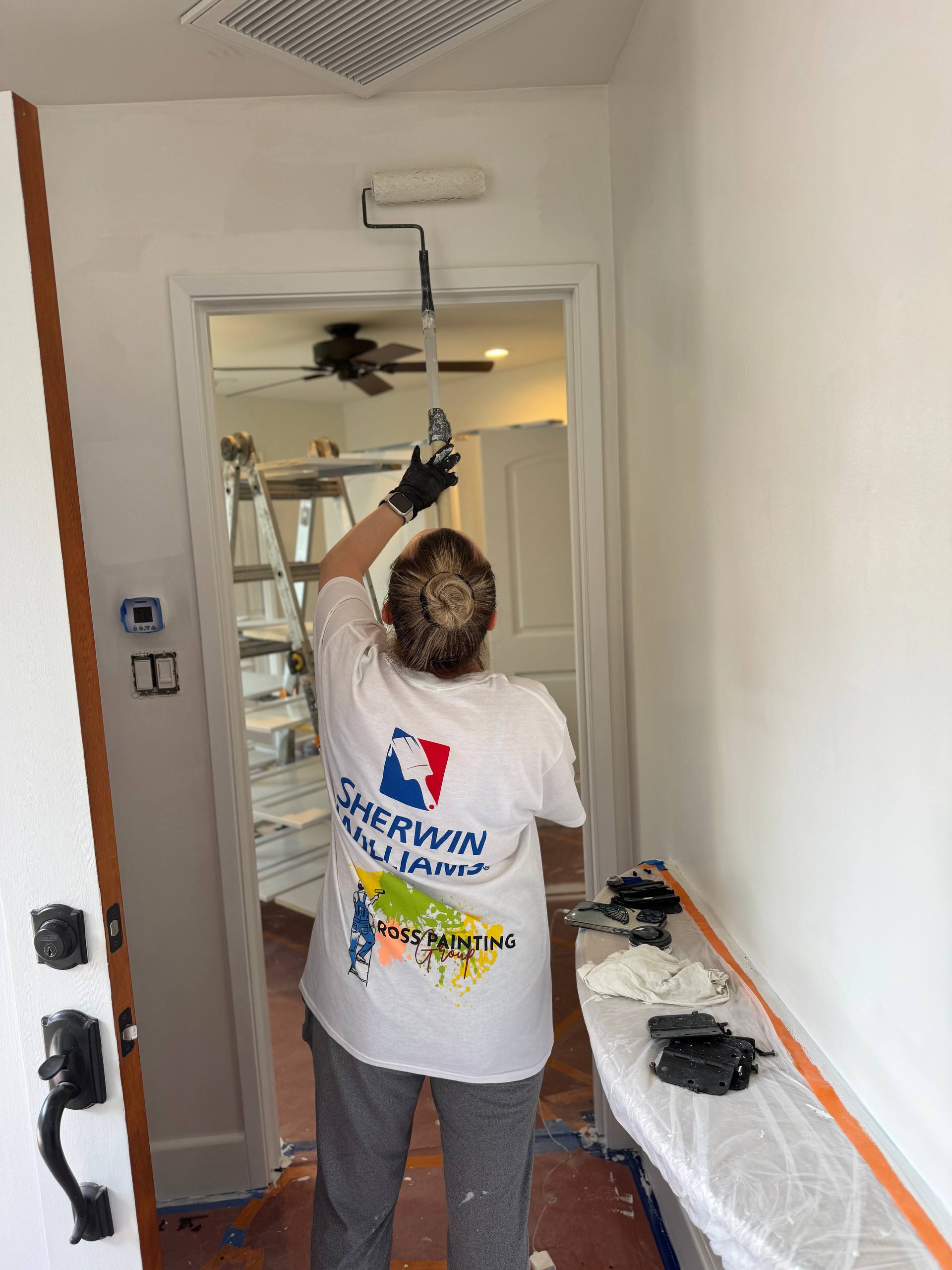 Painter finishing cabinet trim, Orange County