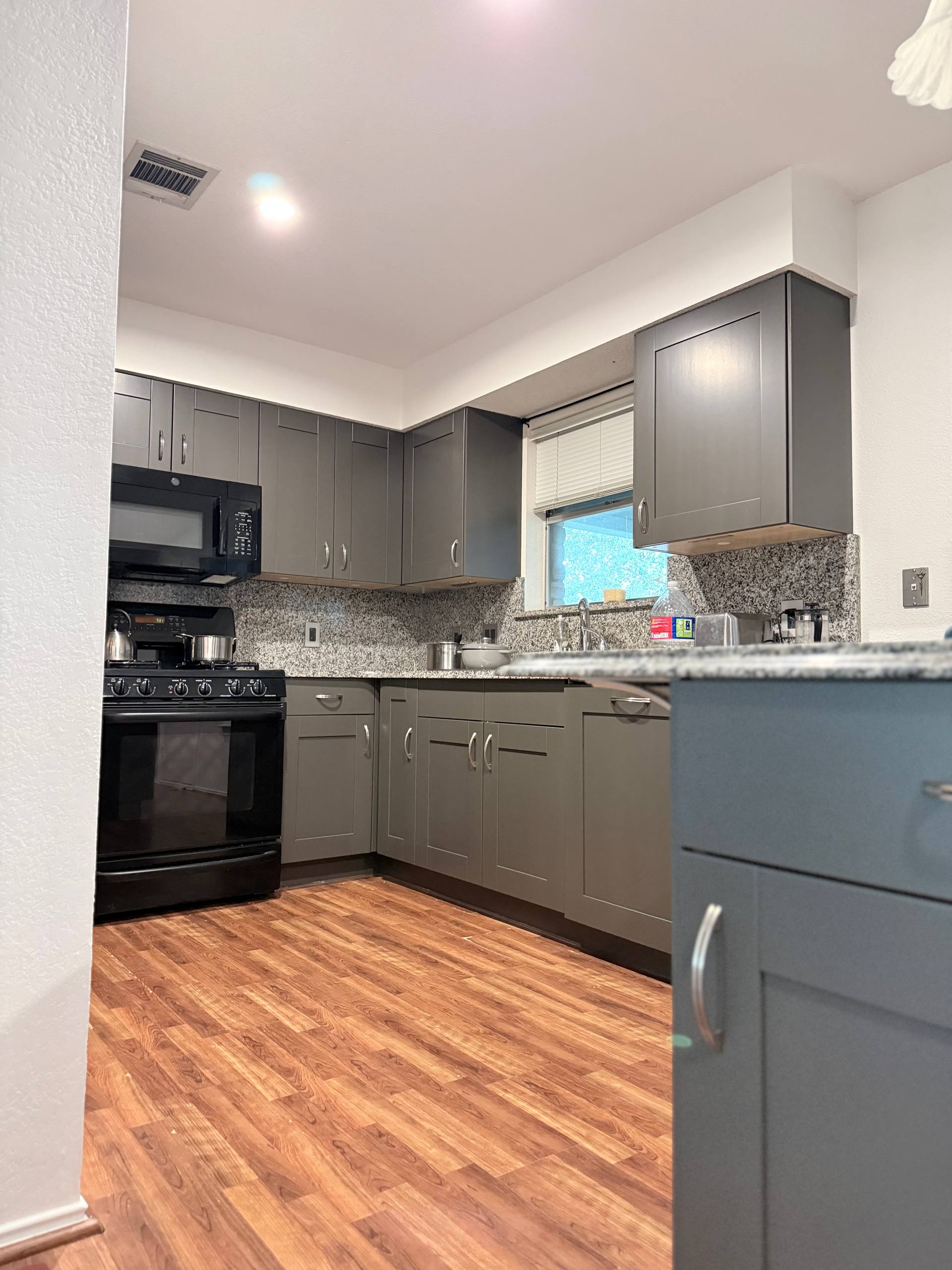 Finished dark stained kitchen cabinets by Ross Painting Group