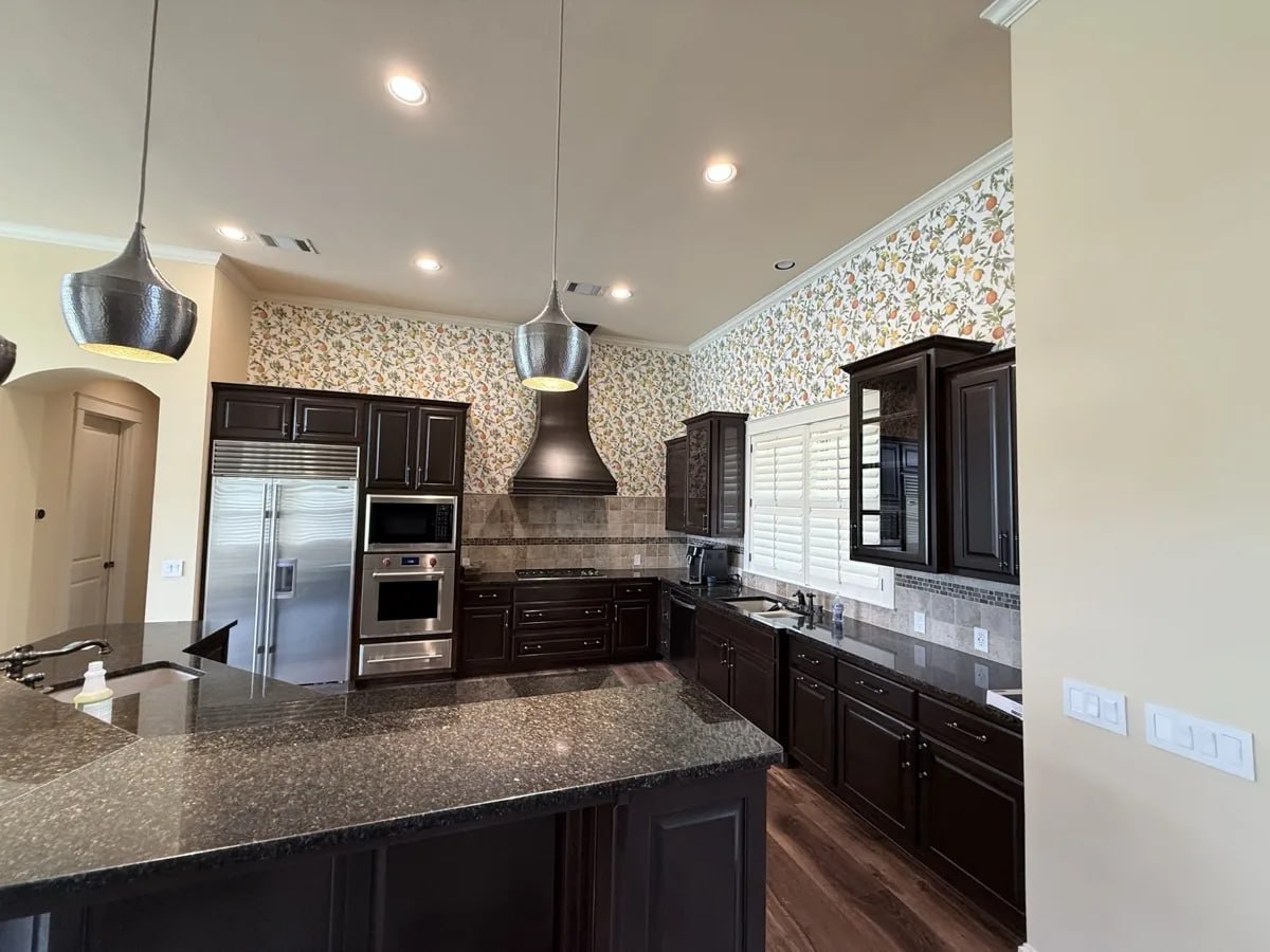 Finished dark stained kitchen cabinets by Ross Painting Group